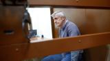Founder of the Baring Vostok private equity group Michael Calvey, who was detained on suspicion of fraud, sits inside a defendants' cage as he attends a court hearing in Moscow, Russia, February 15, 2019, photo by Tatyana Makeyeva/Reuters