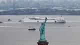 The U.S. Navy hospital ship Comfort passes the Statue of Liberty as it enters New York Harbor during the COVID-19 outbreak, March 30, 2020, photo by Mike Segar/Reuters