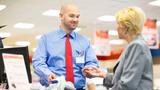 Woman paying a cashier with a credit card