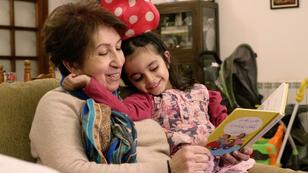 A young girl reading with her grandmother, photo by Malek Hosni
