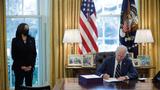 President Joe Biden signs the American Rescue Plan with Vice President Kamala Harris looking on, in the Oval Office at the White House in Washington, D.C., March 11, 2021, photo by Tom Brenner/Reuters