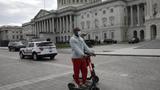 Two men ride electric scooters on Capitol Hill in Washington D.C., March 20, 2020, photo by Gripas Yuri/ABACA via Reuters