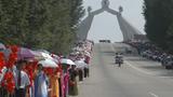 People take part in the celebrations for the National Liberation Day near the Arch of Reunification in the city of Pyongyang, North Korea, August 14, 2005, photo by Yuri Maltsev/Reuters