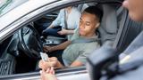 A young man is pulled over for speeding, photo by SDI Productions/Getty Images