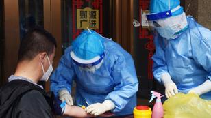 A worker from the city's center for disease control and prevention draws blood from a man to conduct a test for antibodies against COVID-19 in Suifenhe, China, April 16, 2020, photo by Huizhong Wu/Reuters
