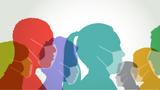 Colourful silhouettes of people of various races wearing face masks, photo by smartboy10/Getty Images