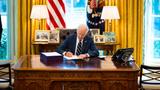 President Joe Biden signs the American Rescue Plan in the Oval Office, at the White House in Washington, D.C., March, 11, 2021, photo by Doug Mills/Pool/Sipa USA/Reuters
