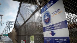 A suicide prevention sign on the fence on the walkway of the George Washington Bridge between New York and New Jersey, January 12, 2022, photo by Mike Segar/Reuters