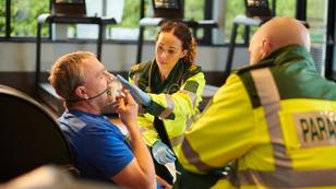 Paramedics treat a man at the gym, photo by sturti/Getty Images