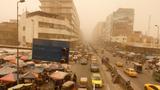 Cars drive and residents gather at the Shorja wholesale market during a sandstorm in Baghdad, Iraq, July 3, 2022, photo by Ahmed Saad/Reuters