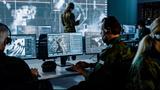 Military Surveillance Officer Working on a City Tracking Operation in a Central Office Hub for Cyber Control and Monitoring for Managing National Security, Technology and Army Communications.