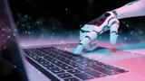Robotic hand pressing a keyboard on a laptop, photo by Guillaume/Getty Images