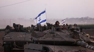 An Israeli soldier looks out from a tank as an artillery unit gathers near Israel's border with the Gaza Strip, in southern Israel, October 12, 2023, photo by Ronen Zvulun/Reuters
