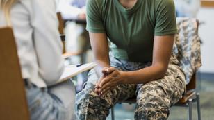 A female soldier leans forward while talking to a mental health professional, photo by SDI Productions/Getty Images