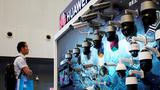 A man looks at surveillance cameras displayed at Huawei's booth at the security exhibition in Shanghai, China, May 24, 2019, photo by Aly Song/Reuters