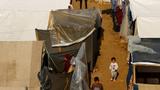 Displaced Palestinian children walk at a tent camp in Khan Younis, southern Gaza Strip, November 14, 2023, photo by Ibraheem Abu Mustafa/Reuters