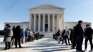 Visitors stand in line outside the U.S. Supreme Court