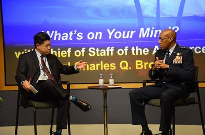 Photo of RAND employee Jim Chow speaking on a panel with Air Force Chief of Staff Gen Charles Q. Brown.