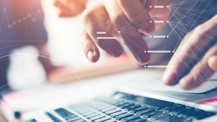 Close-up photo of person working on laptop computer.