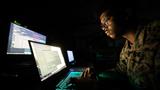 A data systems administrator with Headquarters Battalion, 23rd Marine Regiment, San Francisco works in the dark