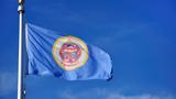 Minnesota state flag against a blue sky, photo by herreid/Getty Images