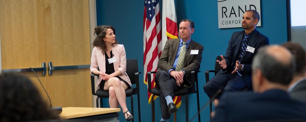 RAND leaders sitting on a panel at a Social and Economic Policy Advisory Board meeting.