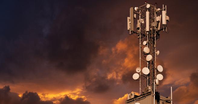 5G network transmitters on the roof of a skyscraper on a background of dramatic sky., photo by scharfsinn86/Adobe Stock