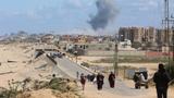 Smoke rises following an Israeli strike as Palestinians fleeing north Gaza due to Israel's military offensive move southward at the central Gaza Strip, March 15, 2024, photo by Ahmed Zakot/Reuters