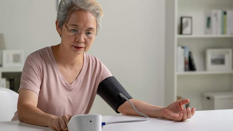 Senior woman measuring her blood pressure at home, photo by amenic181/Adobe Stock