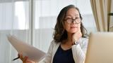 Concentrated asian middle aged female businesswoman using portable computer, photo by bongkarn/Adobe Stock
