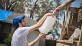 A Louisiana resident receives ice from an Oklahoma National Guardsman at a neighborhood in LaPlace, Louisiana, Sept. 7, 2021. Photo by Senior Airman Alex Kaelke/Oklahoma National Guard