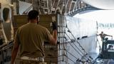 Air Force Staff Sgt. Dave Servida directs weapons cargo bound for Ukraine onto a C-17 Globemaster III at Dover Air Force Base, Delaware, August 19, 2022, photo by Airman 1st Class Cydney Lee/U.S. Air Forc