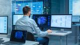 Man sitting at a computer with neural networks on the screens, photo by gorodenkoff/Getty Images