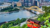 A car on the Duquesne Incline with a view of downtown Pittsburgh in the background, photo by aoldman/Getty Images