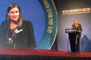 Photo of Sherrill Lingel speaking at a conference about technology and defense modernization.