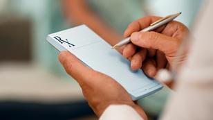 Closeup of a doctor writing a prescription in a prescription pad, photo by stevecoleimages/Getty Images