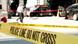 Shooting crime scene in the middle of a busy intersection with police tape blocking the scene, photo by 400tmax/Getty Images