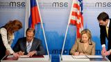 Then-U.S. Secretary of State Hillary Clinton and Russian Foreign Minister Sergei Lavrov signing documents on the new launch agreement at the 47th Security Conference in Munich, Germany, February 5, 2011, photo by Tobias Hase/DPA Pictures Alliance via Reuters