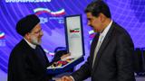 Venezuela's President Nicolas Maduro presents then-Iranian President Ebrahim Raisi with the Orden Libertadores y Libertadoras de Venezuela decoration as they meet at the Miraflores Palace, in Caracas, Venezuela, June 12, 2023, photo by Leonardo Fernandez Viloria/Reuters