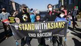 An Asian family holding a banner that says Stand with Asians during an Asian Justice Rally in San Francisco, California, January 30, 2022, photo by Michael Ho Wai Lee/SOPA Images via Reuters