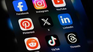 Closeup of a cel phone with social media icons on the screen, photo by Kenneth Cheung/Getty Images