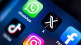 Close-up view of a mobile phone screen focused on social media icons, including X, TikTok, Facebook, and Instagram, photo by Jess rodriguez/Adobe Stock