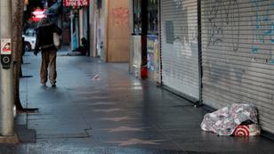 A person experiencing homelessness sleeps unsheltered on the Walk of Fame in Hollywood, California, February 6, 2020, photo by Mike Blake/Reuters