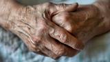 An elderly woman's hands clasped, photo by fortton/Adobe Stock