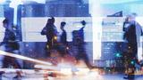 People walking in a city, surrounded by lights and a blur of motion, image by kieferpix/Adobe Stock
