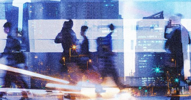 People walking in a city, surrounded by lights and a blur of motion, image by kieferpix/Adobe Stock