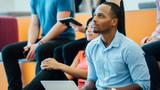 Group of people enjoying a lecture in a modern auditorium. Photo by Adobe Stock/Inti St. Clair