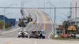 A Lee County deputy sheriff checks a driver at the closed Fort Myers Beach bridge as Hurricane Milton approaches Fort Myers, Florida, October 9, 2024, photo by Ricardo Arduengo/Reuters