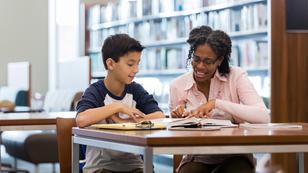 A middle school student and his teacher sitting in a school library, photo by SDI Productions/Getty Images