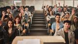College classroom with students, many raising hands, photo by skynesher/Getty Images